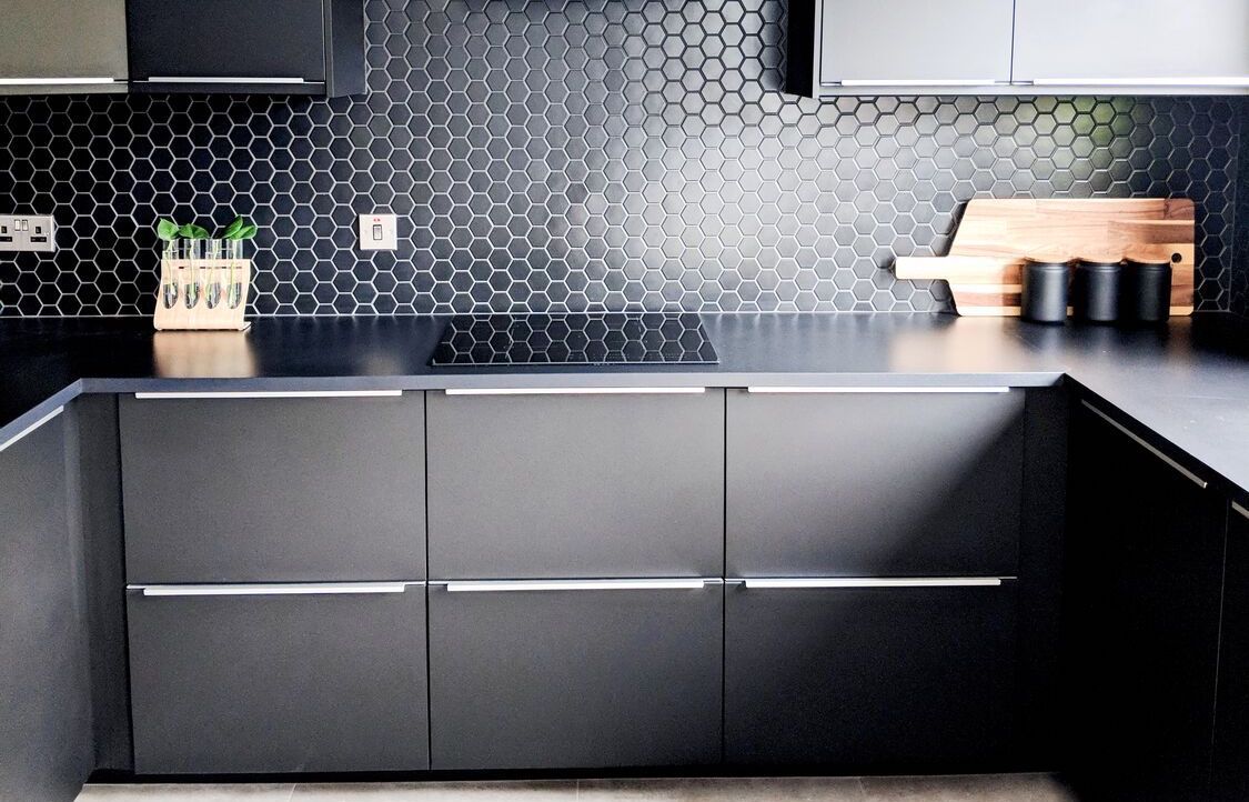 black kitchen cabinets and backsplash