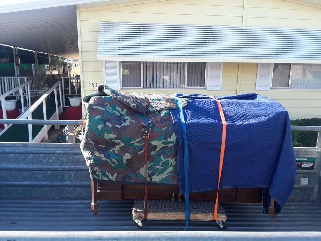 upright piano transport-covered and strapped