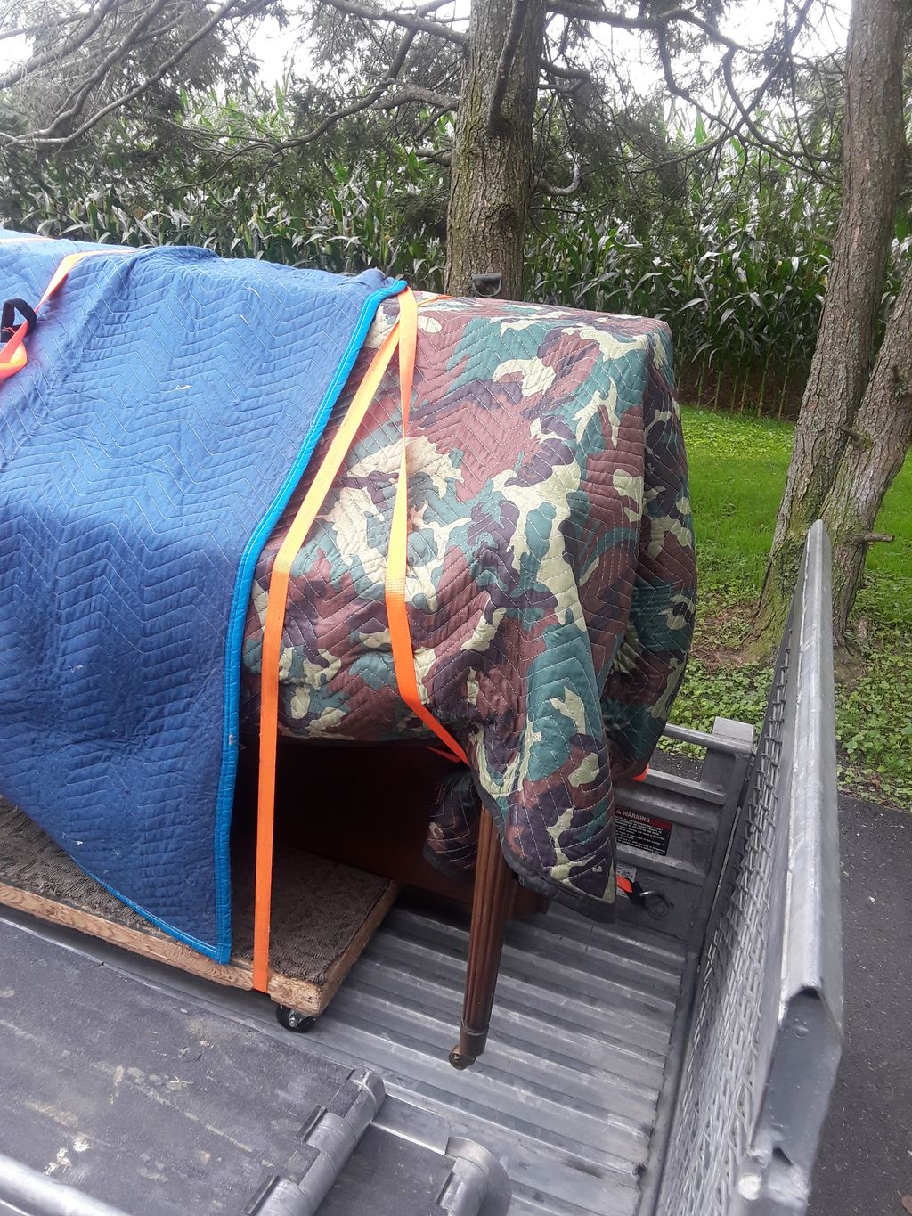 upright spinet piano transport-covered and strappe