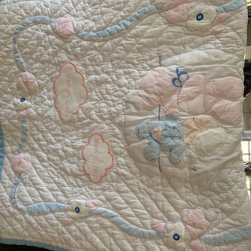 Added two embroidered clouds to an antique quilt m