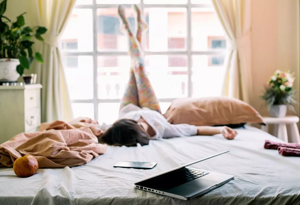 woman relaxing on bed