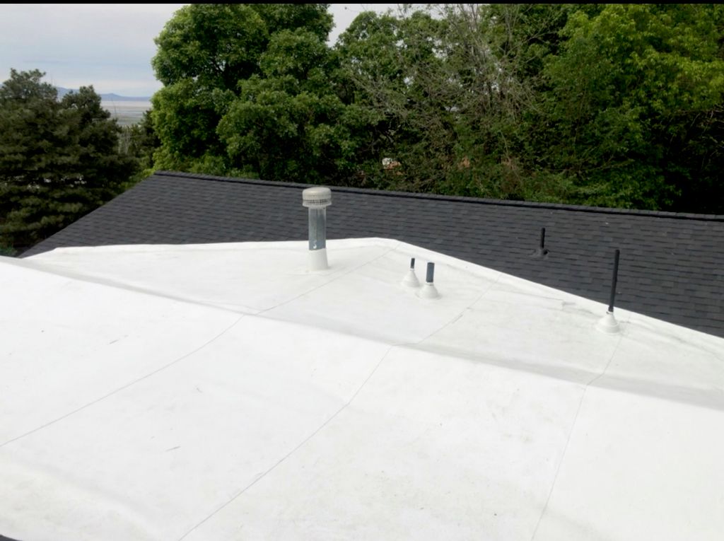 Bountiful roof with shingles and TPO membrane.