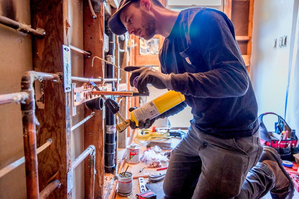 Ryan soldering some copper pipes