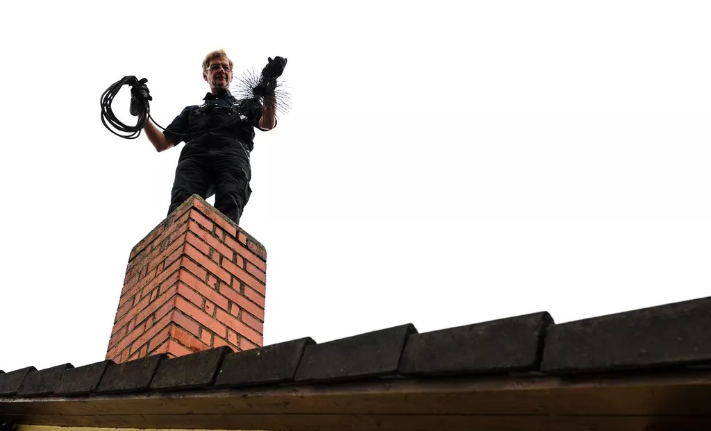 chimney sweeper on roof
