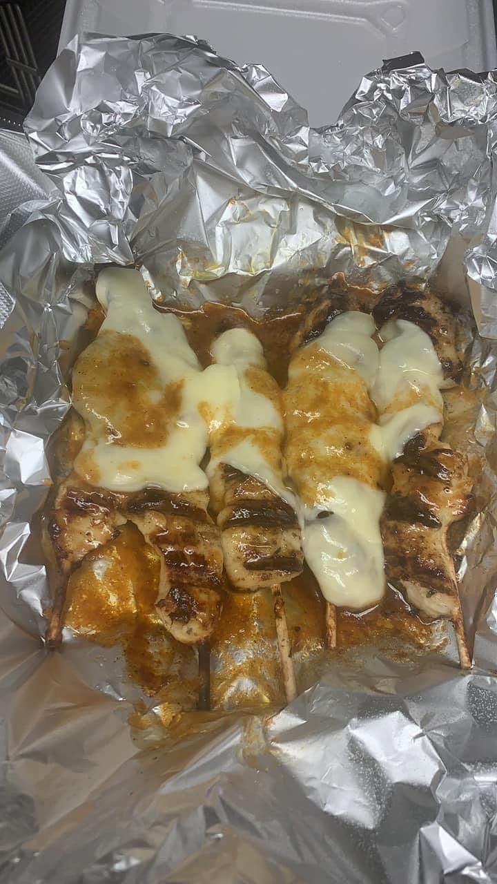 Chicken skewers topped with provolone cheese 