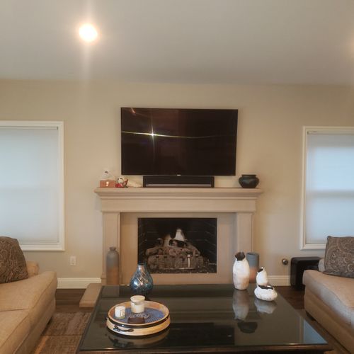 TV and soundbar installation above fireplace