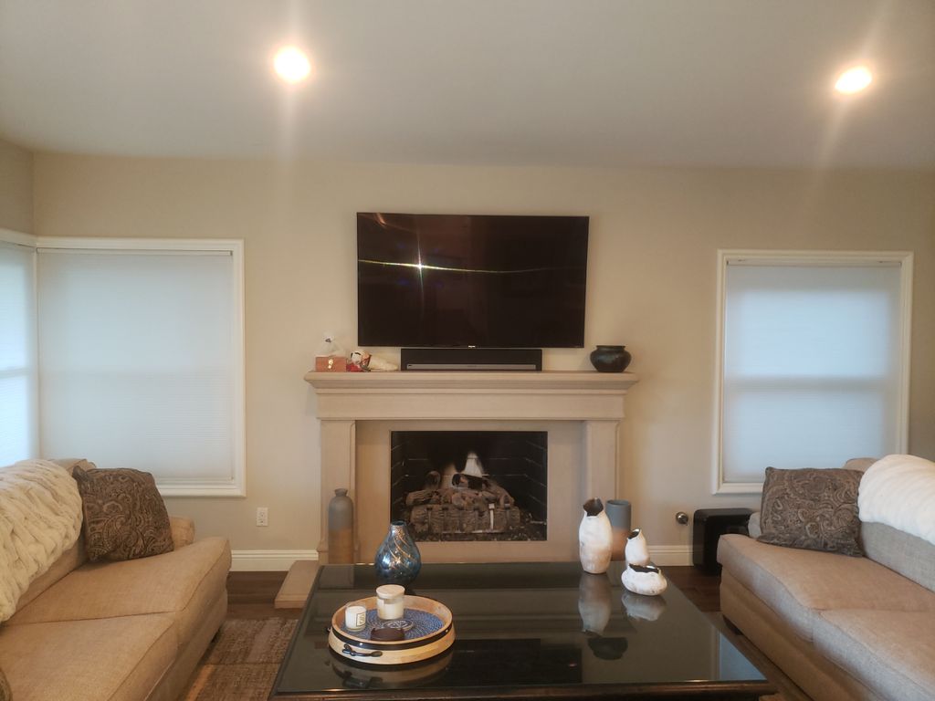 TV and soundbar installation above fireplace