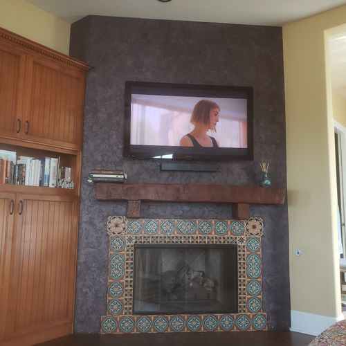 TV and soundbar above fireplace