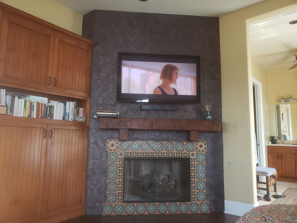 TV and soundbar above fireplace