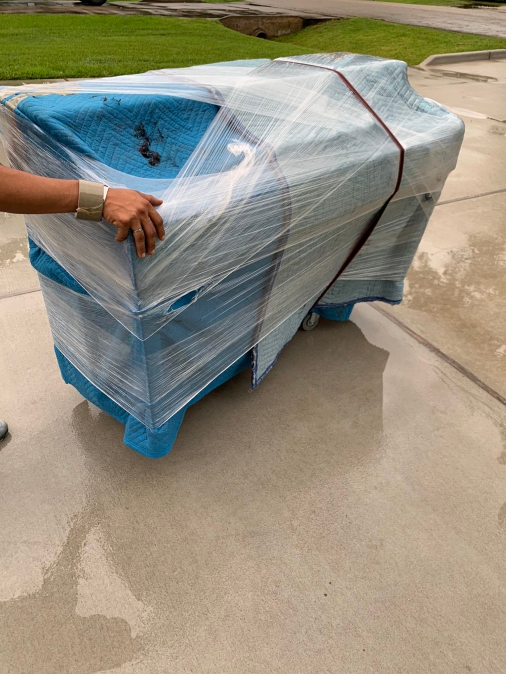 A Console Piano being transferred out onto a new m
