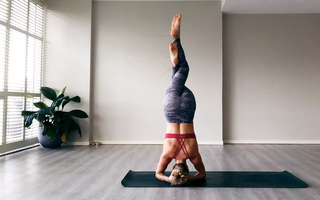 woman doing yoga lessons in room