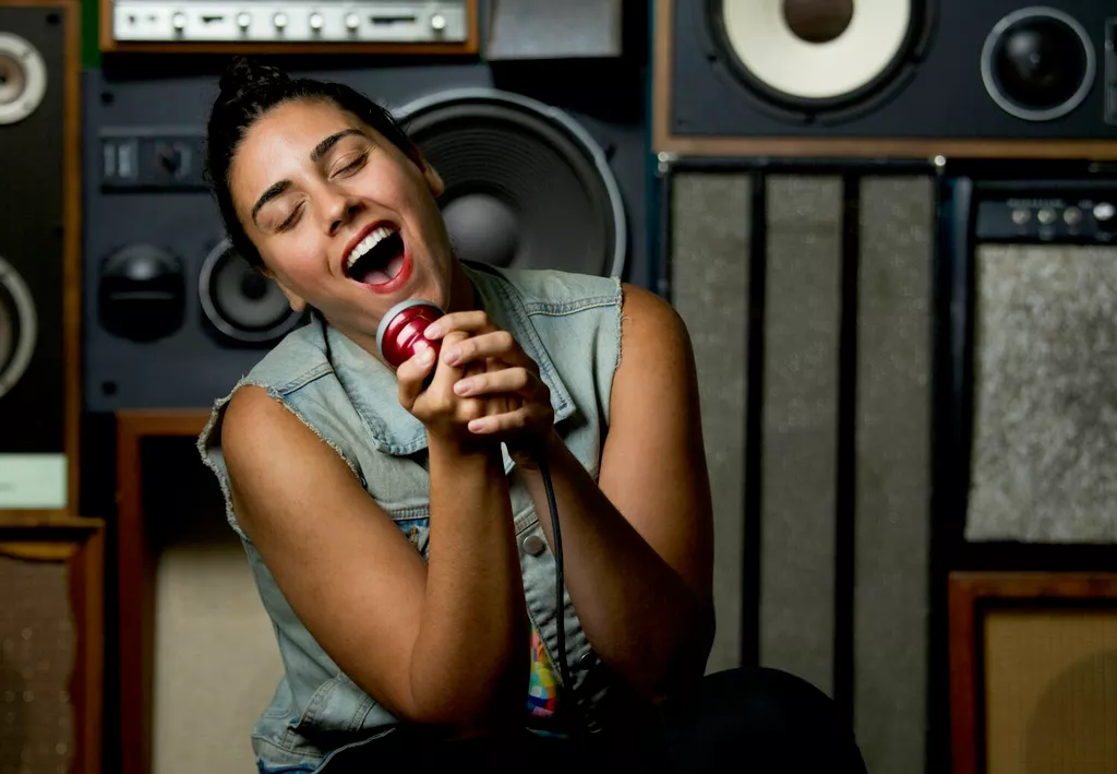 woman singing on microphone