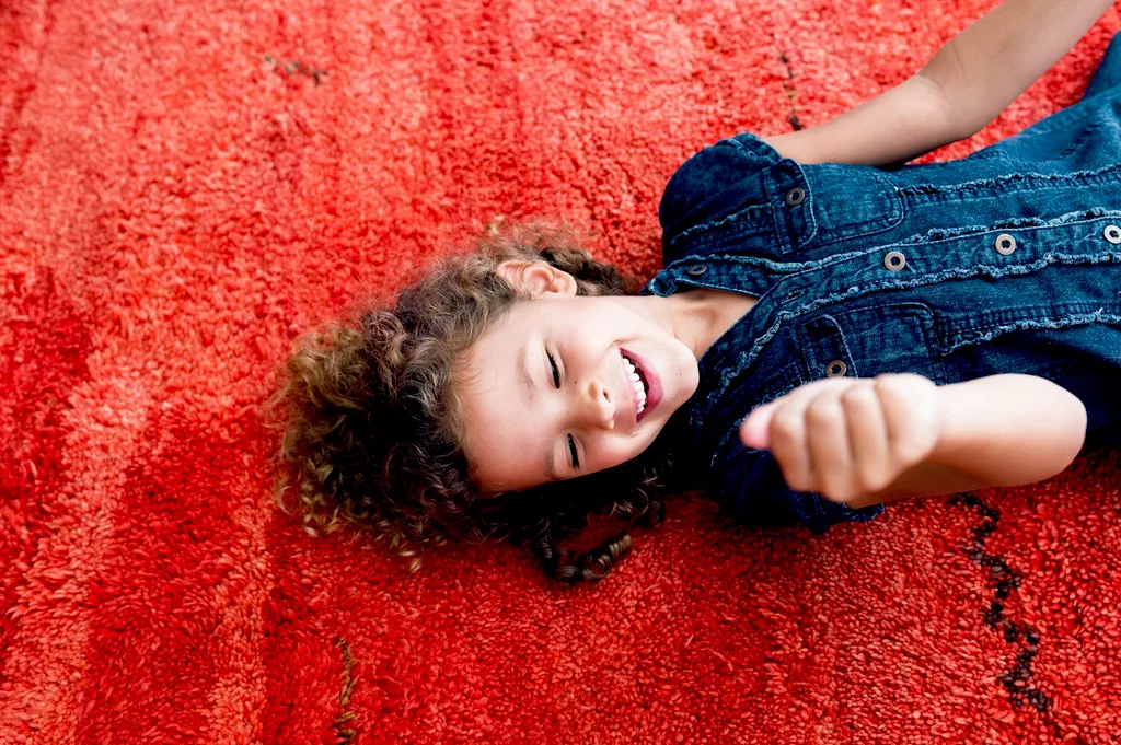 girl laying on carpet