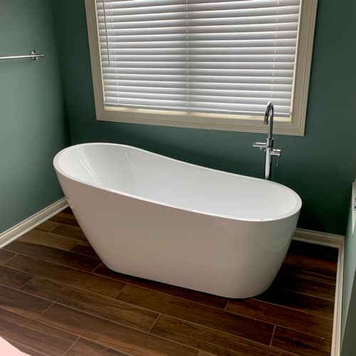 Freestanding tub with Roman faucet