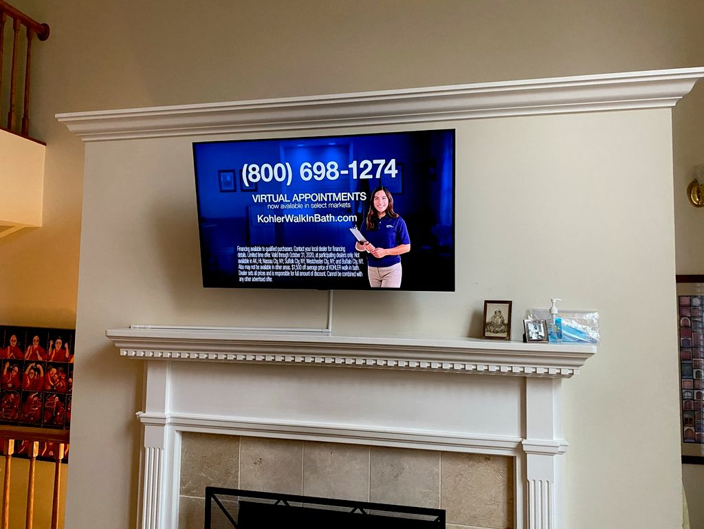 Tv mounting with wiring in conduit for a clean loo