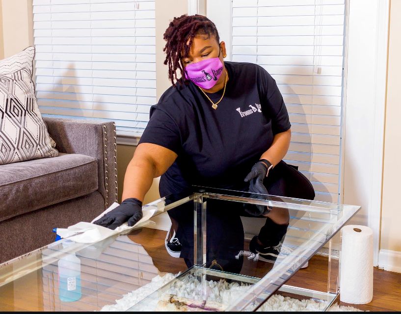 This tech is cleaning the livingroom 