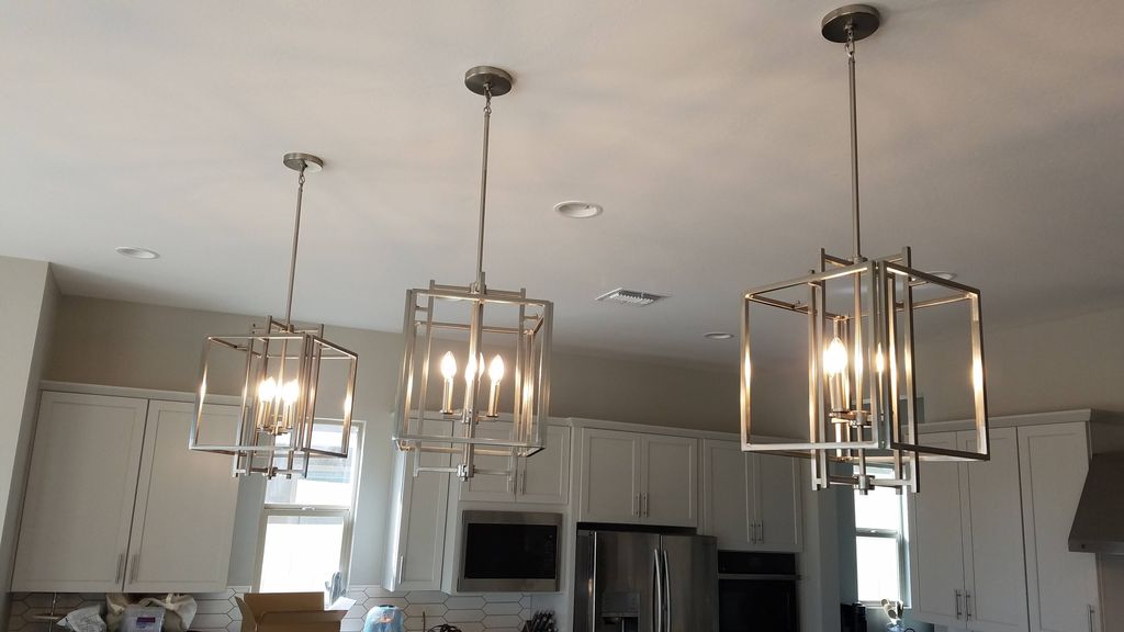 installed 3 modern pendant lights over kitchen isl