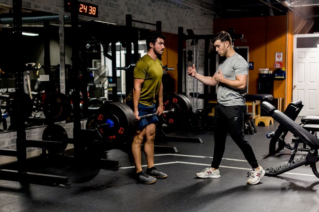 Remo mid performing barbell deadlifts while I cue 