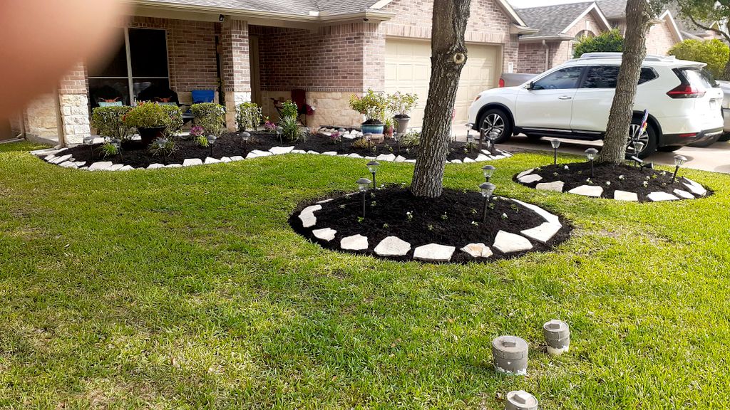 black mulch trimming bushes flowers White stone