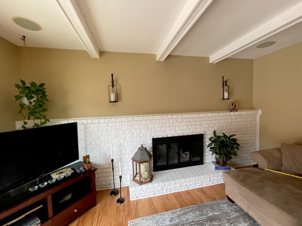 (1/3) BEFORE: 55” TV on mantle.