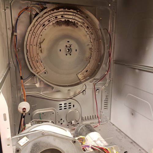 Repairing a commercial dryer.