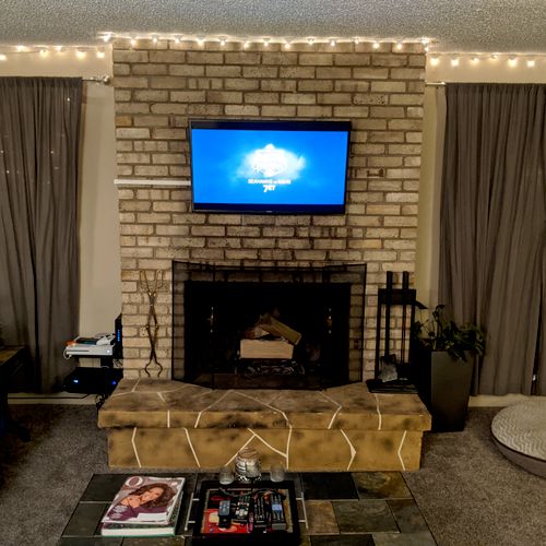 TV on brick fireplace