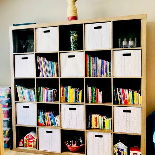 Family room organization with kids books and toys toward the bottom, and breakables and adult items towards the top.  Organized and styled by Amber.