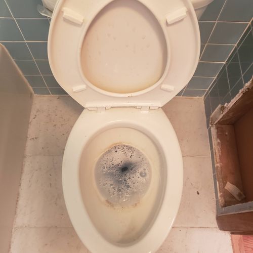 Toilet before cleaning with water deposits 