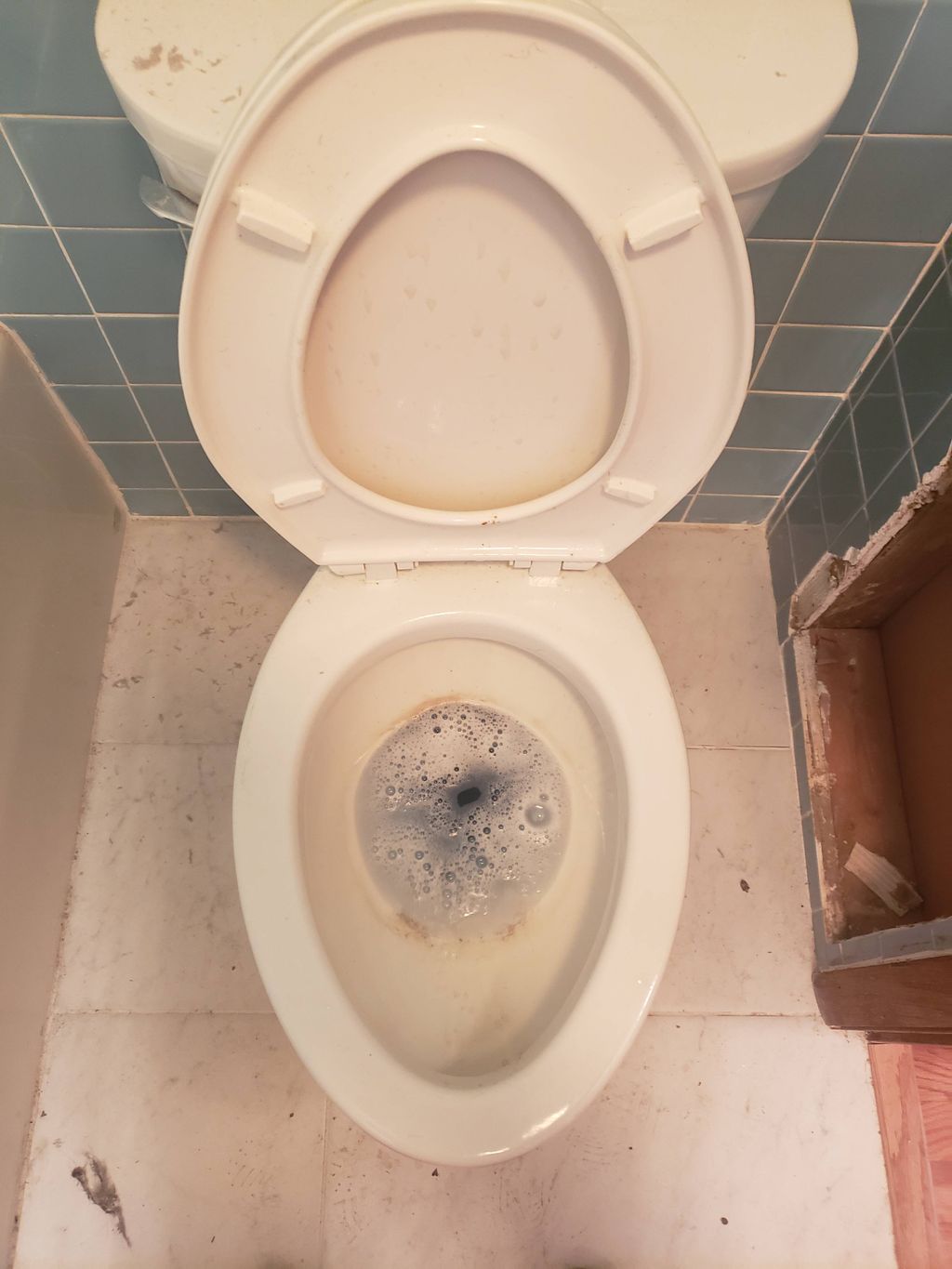 Toilet before cleaning with water deposits 
