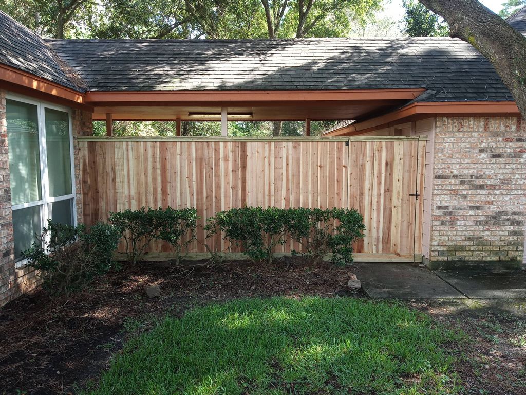 Cedar enclosure with gate.  Top cap and trim addit