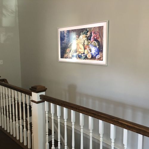 Frame TV as art work over staircase