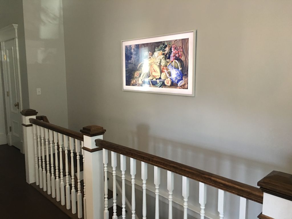 Frame TV as art work over staircase