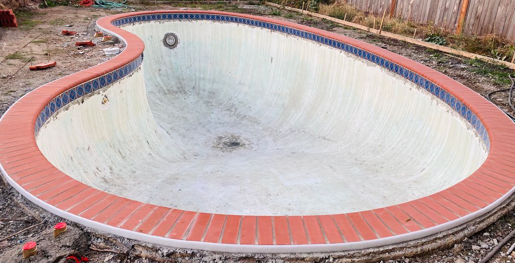 New waterline tile and new brick coping 