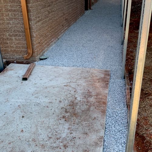 Concrete pad and gravel walkway prior to custom fe