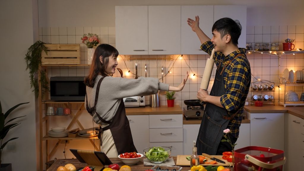 couple dancing to music during date night at home