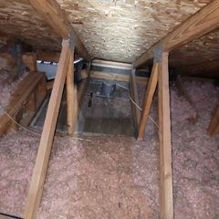 Before picture of an attic that was leaking heat.