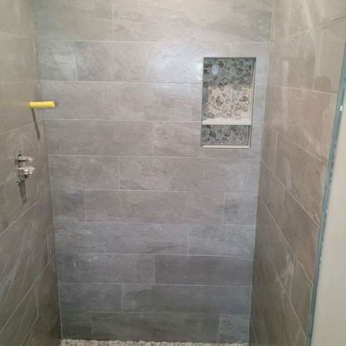 Mike tiled two bathrooms (floor and shower in both