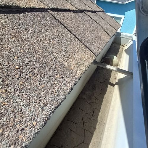 Gutter Caked in Mud with Downspout Blockage