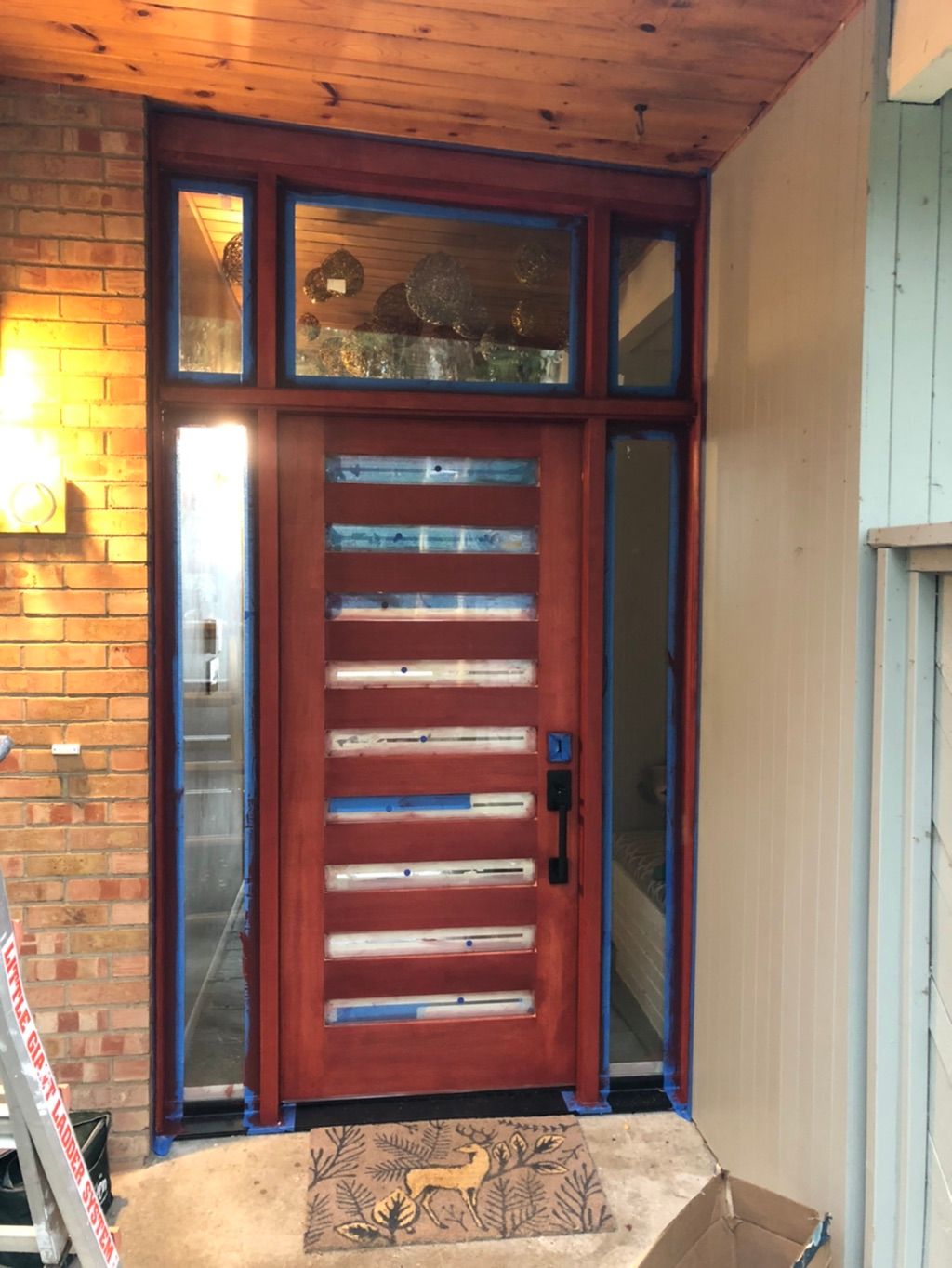 After single exterior door with sidelights and tra