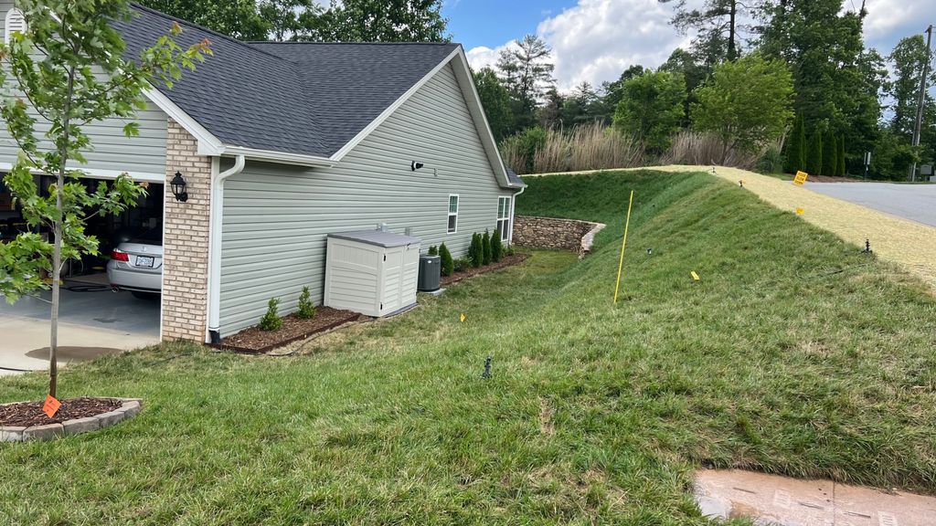 Yard with a negative slope where water drains towards the house.