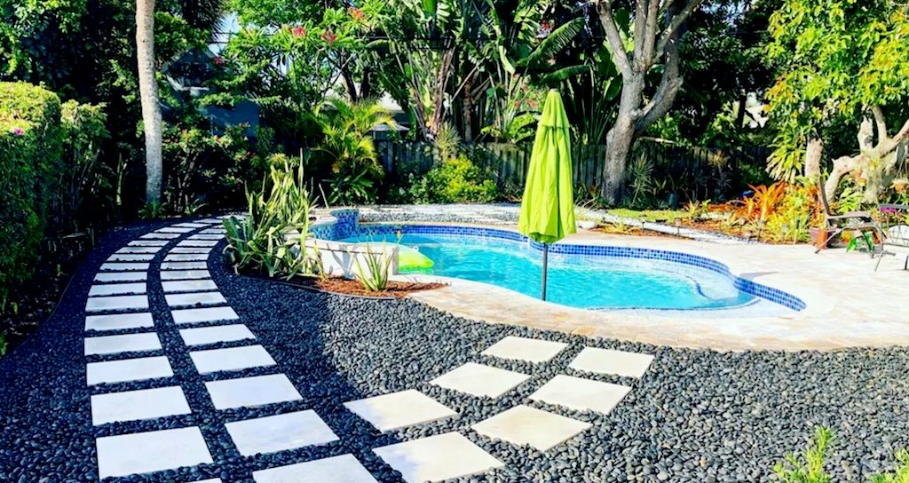 landscape ideas around pool beach pebbles