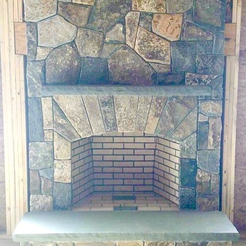 Michael built this stone veneer fireplace.  His pr