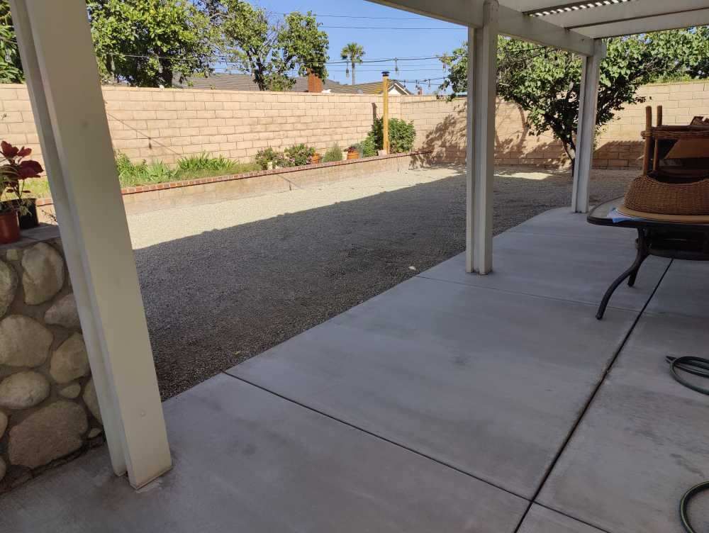 after: laying out gravel in a backyard 