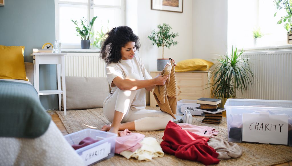 woman packing clothes in bedroom