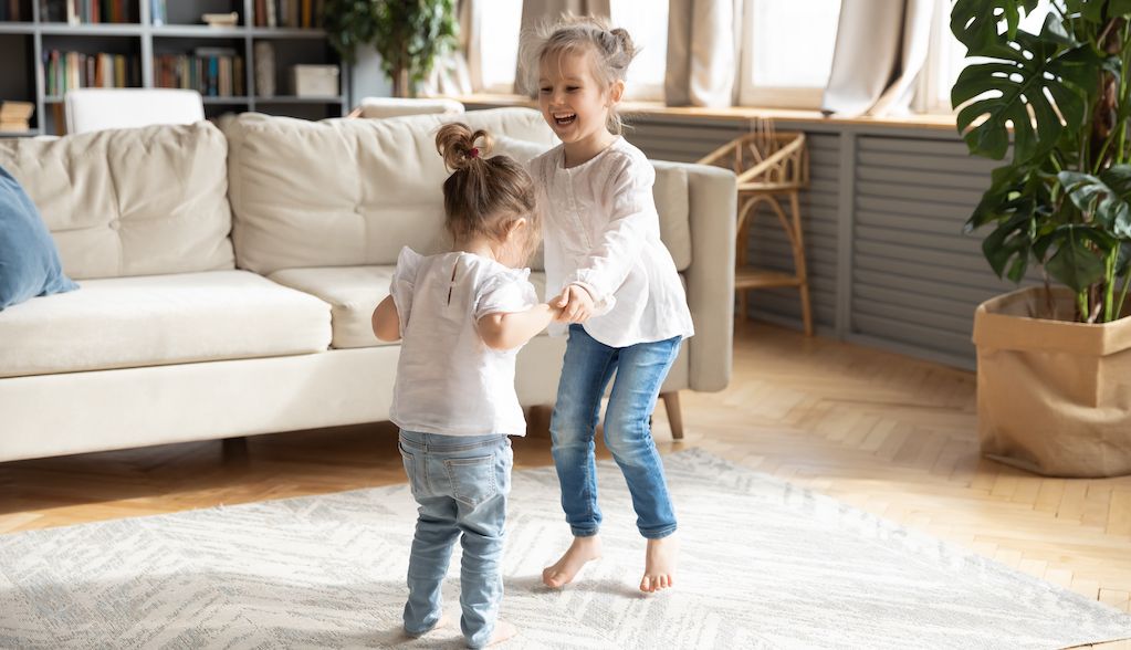 little girls dancing in childproof living room
