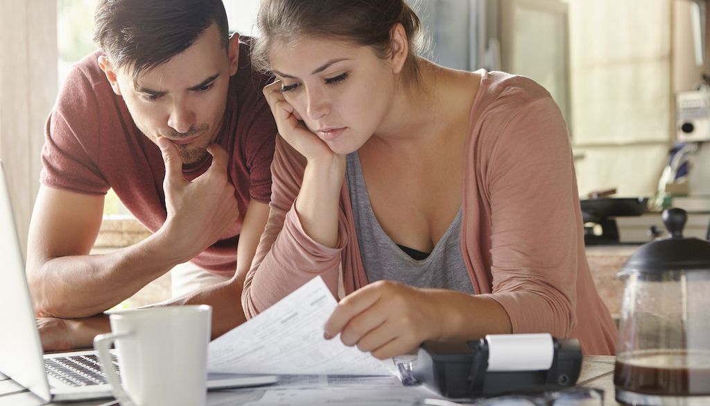 couple analyzing moving expenses at table