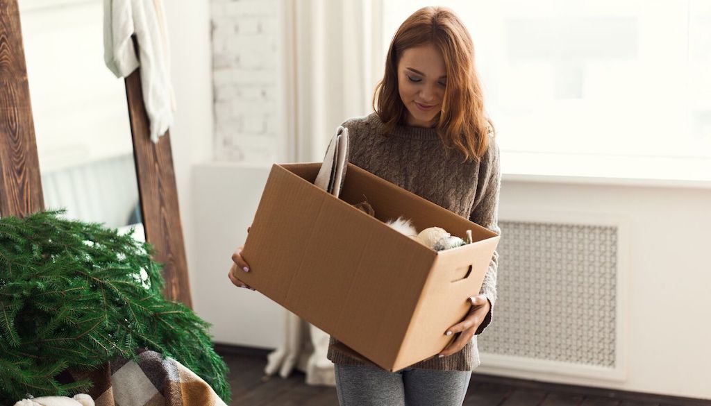 girl holding a moving box