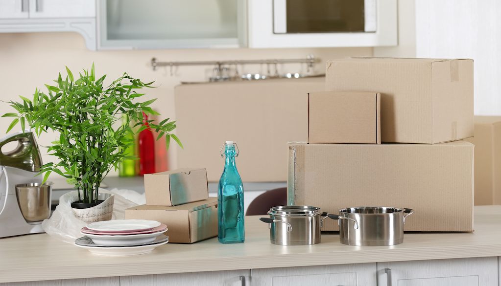 dishes and moving boxes on kitchen counter
