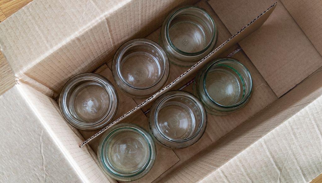 glass jars cups in moving box