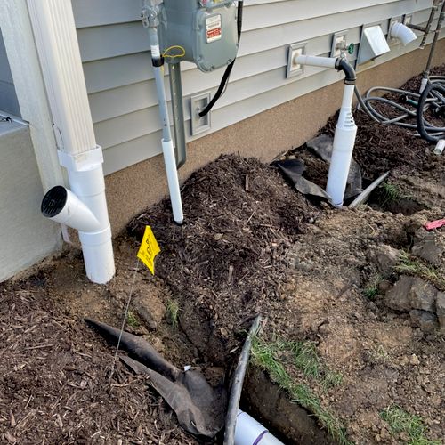 Buried gutter and sump pump outlets on a newer hou